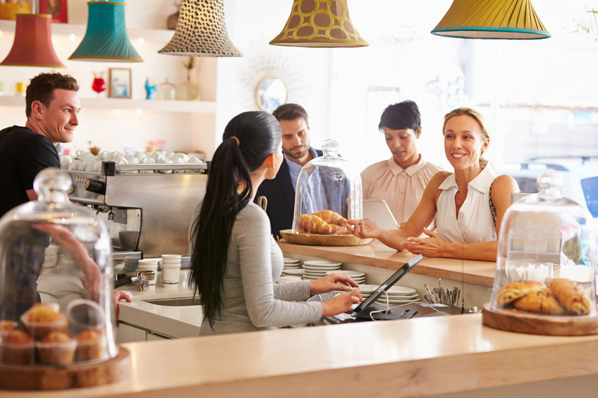 Bakery owners helping customers place an order