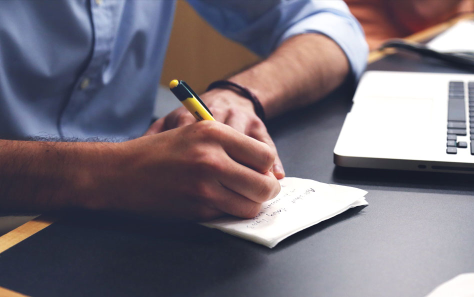 Person writing on a piece of paper