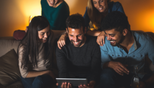 Rapport Innovative Marketing 5 People Gathered Together Smiling and Staring at the Screen of a Tablet