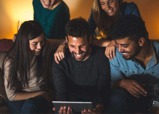 Rapport Innovative Marketing 5 People Gathered Together Smiling and Staring at the Screen of a Tablet